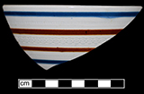 Hemispherical bowl banded in blue and brown with routletting - from 18BC139.
